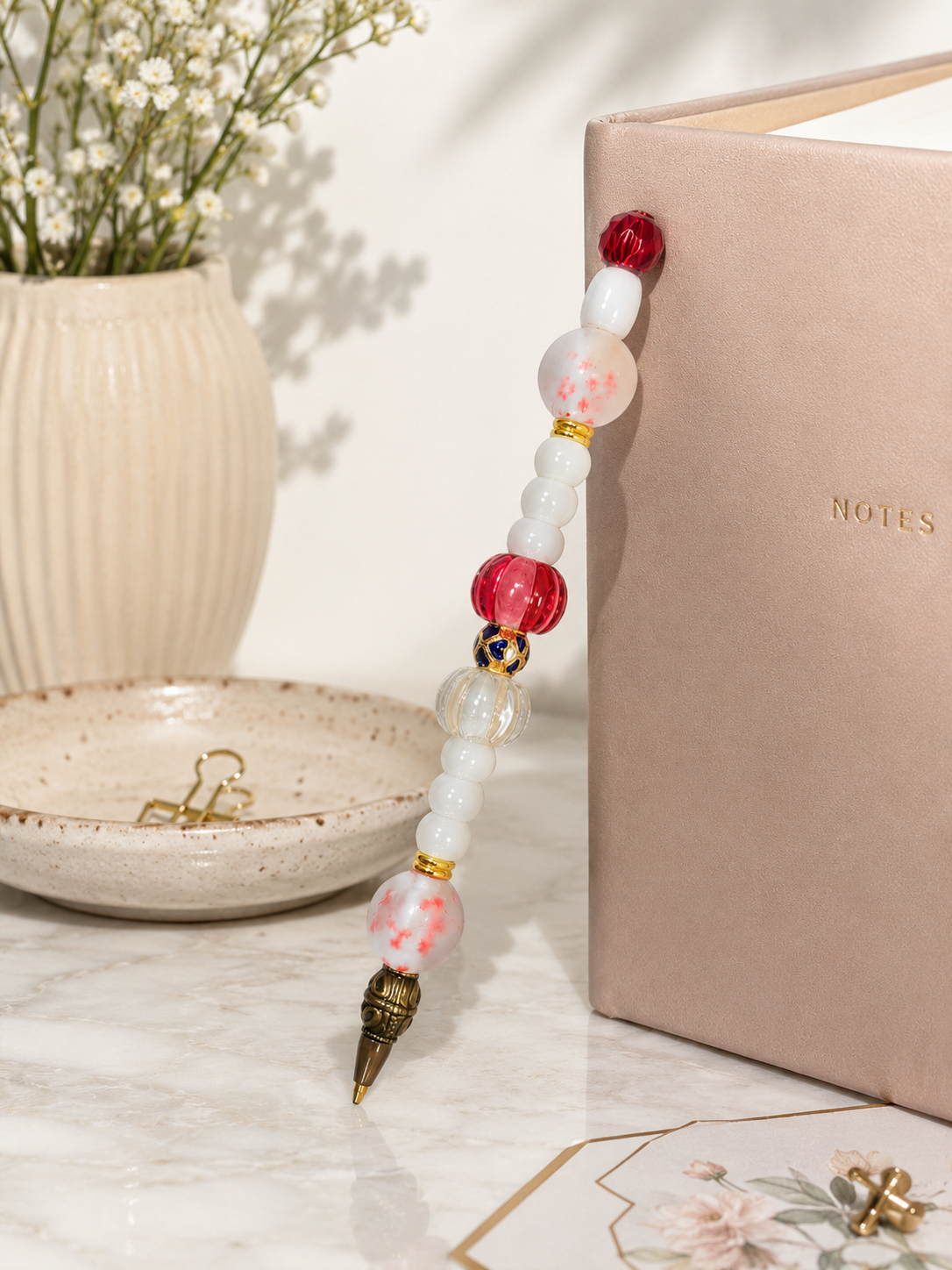 Elegant desk vignette with the Cranberry & Cream beaded pen